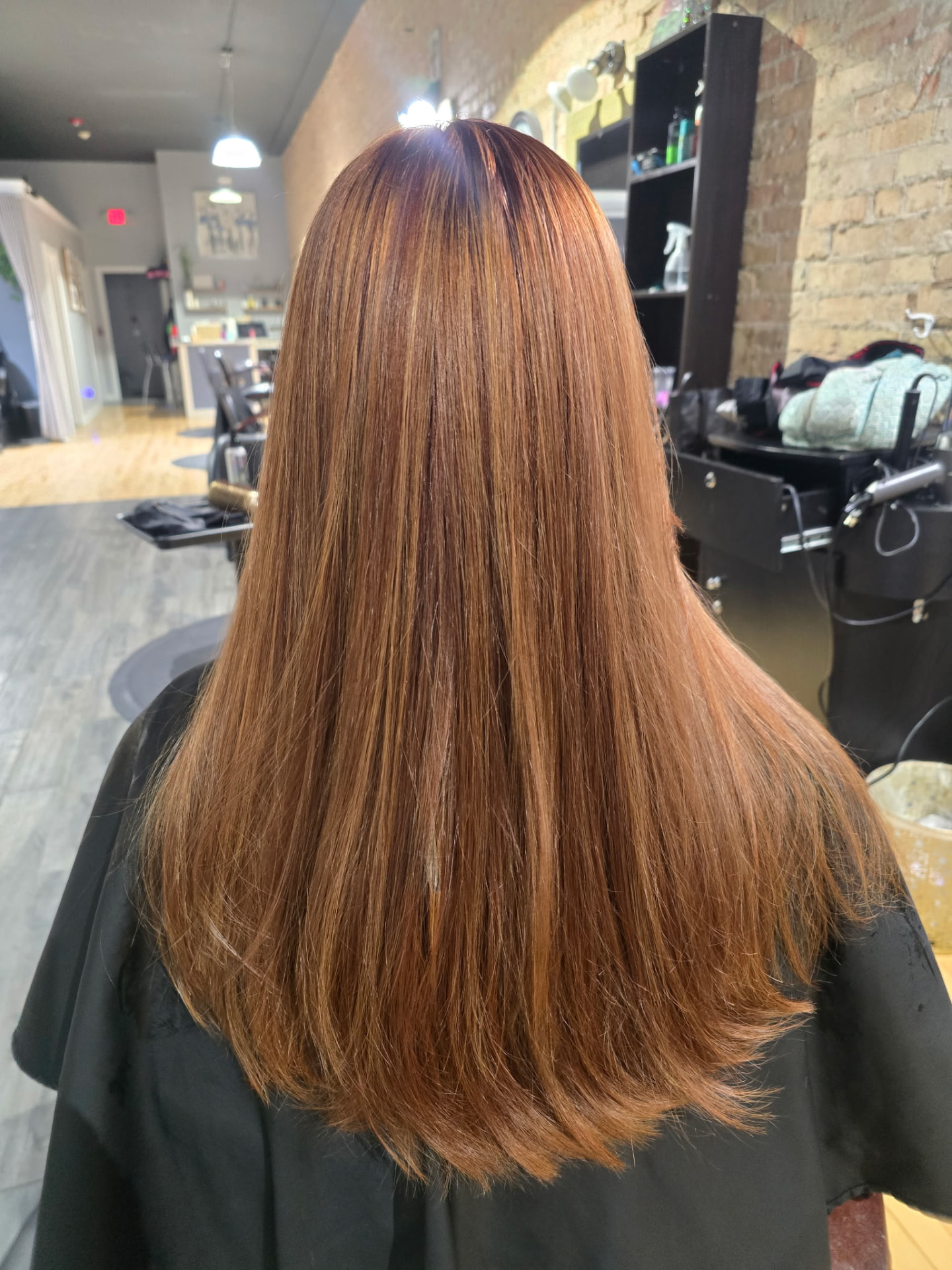 Copper red root touch-up with gloss, full highlight and smooth blowout at Studio K Hair Studio Lockport IL